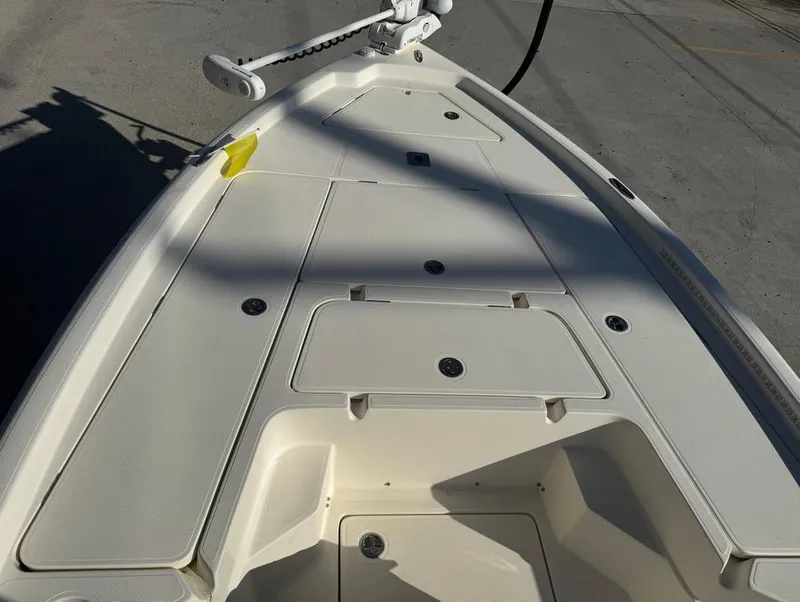 Slide: The Image of 2019 Skeeter SX 240 boat deck with storage compartments and trolling motor. - 16