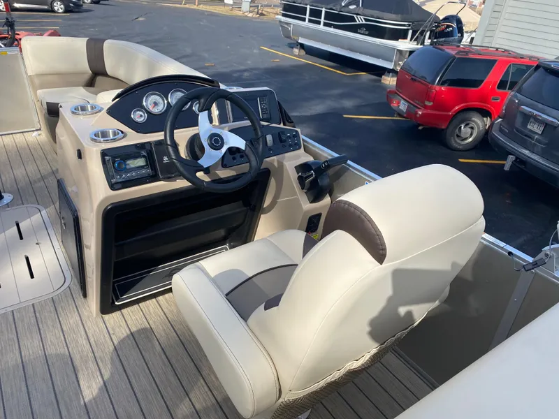 Slide: The Image of 2025 SunCatcher Select 322SS boat interior with steering console and seating. - 17