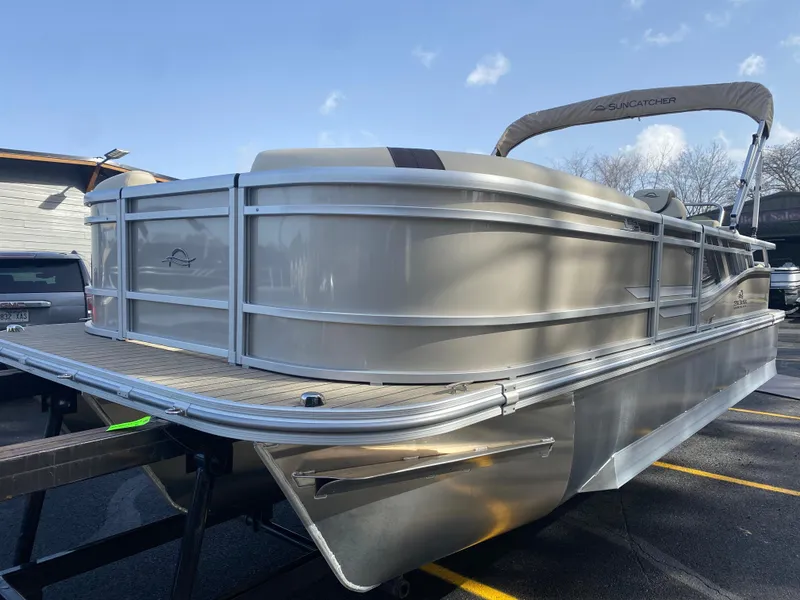 Slide: The Image of 2025 SunCatcher Select 322SS pontoon boat on trailer, side view. - 2