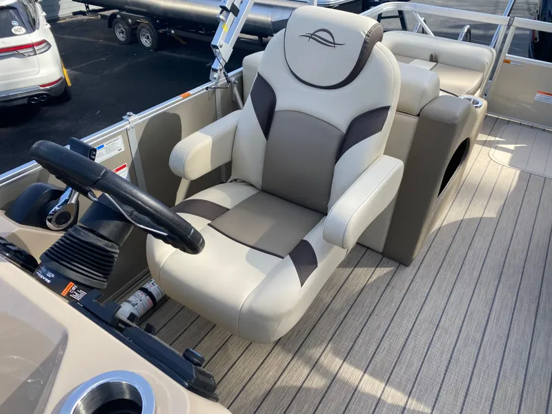 Slide: The Image of 2025 SunCatcher Select 322SS boat captain's chair with steering wheel on deck. - 22