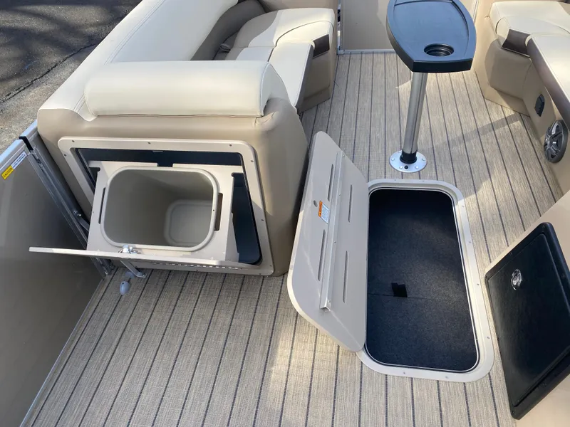 Slide: The Image of 2025 SunCatcher Select 322SS interior with storage compartments and seating. - 24