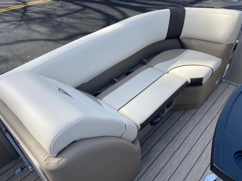 Slide: The Image of 2025 SunCatcher Select 322SS boat interior with beige seating and wood-textured flooring. - 25
