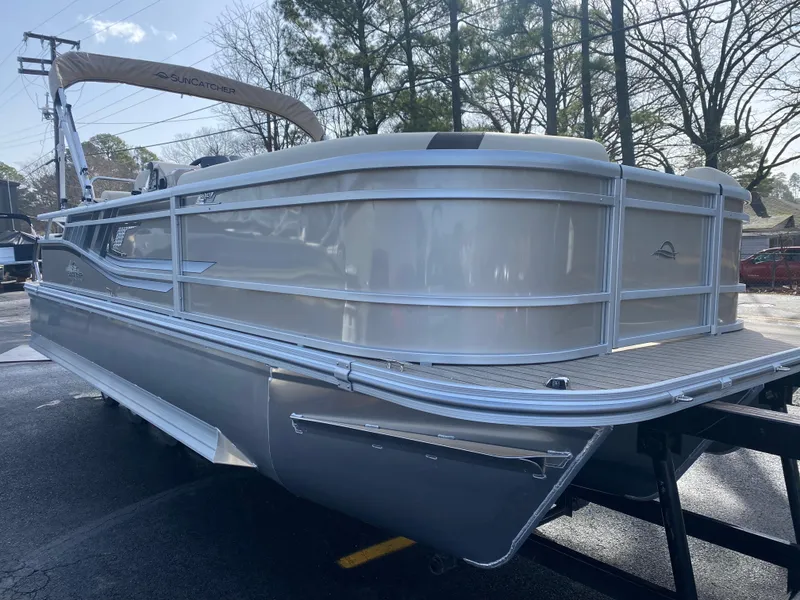 Slide: The Image of 2025 SunCatcher Select 322SS pontoon boat in a parking lot, side view. - 3