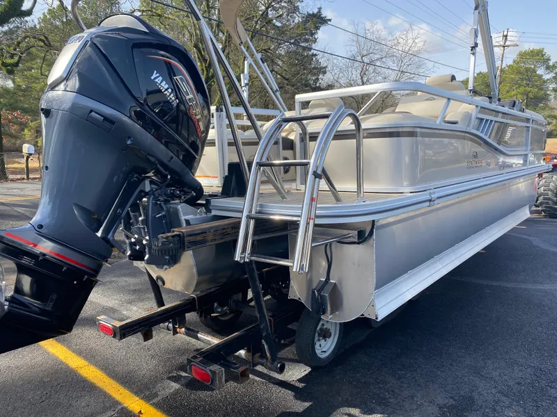 Slide: The Image of 2025 SunCatcher Select 322SS pontoon boat with Yamaha outboard motor, parked on trailer. - 5