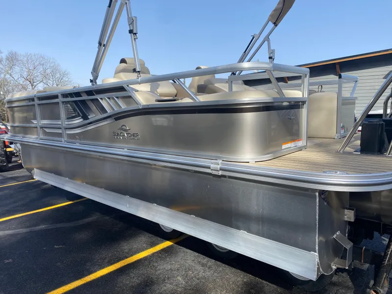 Slide: The Image of 2025 SunCatcher Select 322SS pontoon boat in a parking lot, side view. - 6