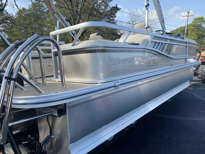 Slide: The Image of 2025 SunCatcher Select 322SS pontoon boat, sleek design, silver finish, outdoor setting. - 8