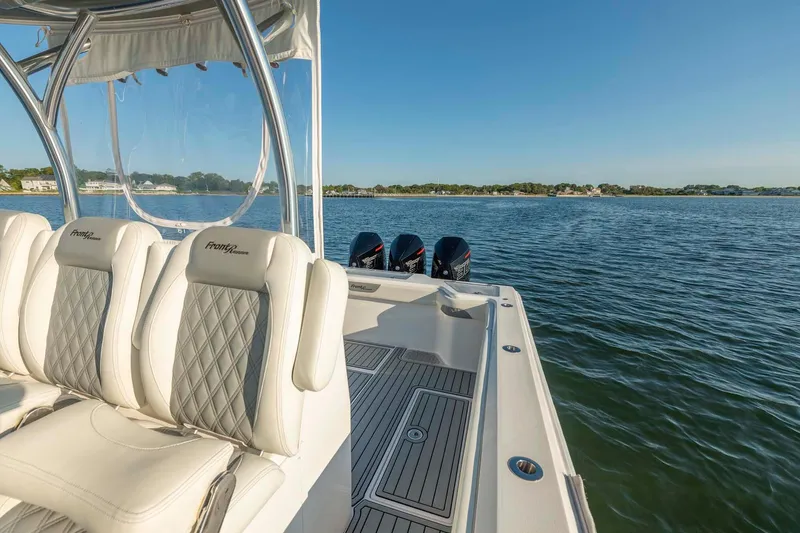 Slide: The Image of 2021 Front Runner 36 Center Console boat on water, featuring luxurious seating and triple engines. - 17