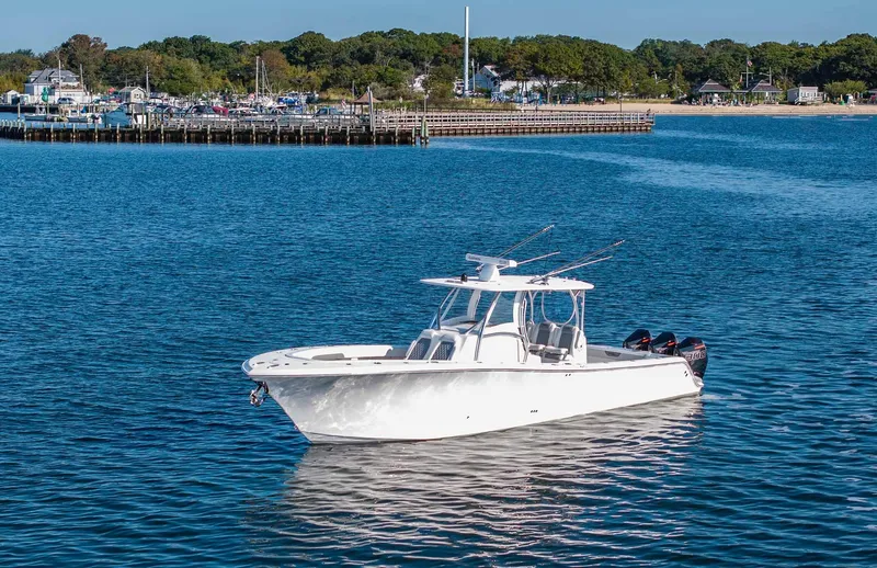 Slide: The Image of 2021 Front Runner 36 Center Console boat on calm water near a marina. - 31