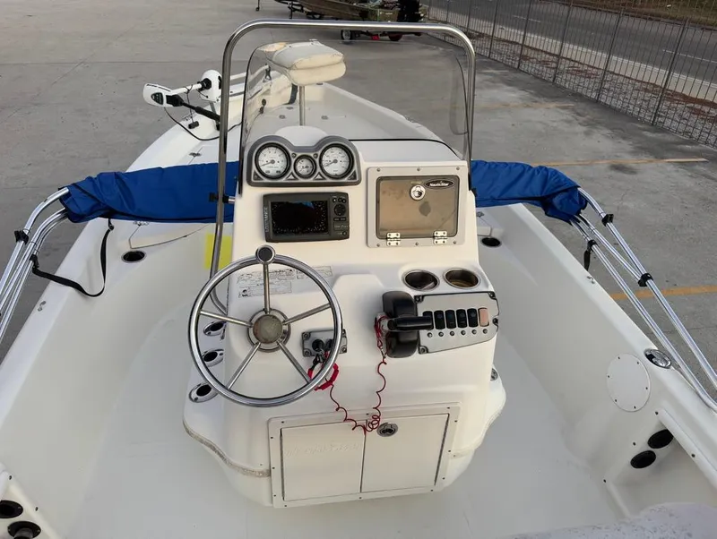 Slide: The Image of 2014 NauticStar 215 XTS Shallow Bay boat dashboard with steering wheel and controls. - 11