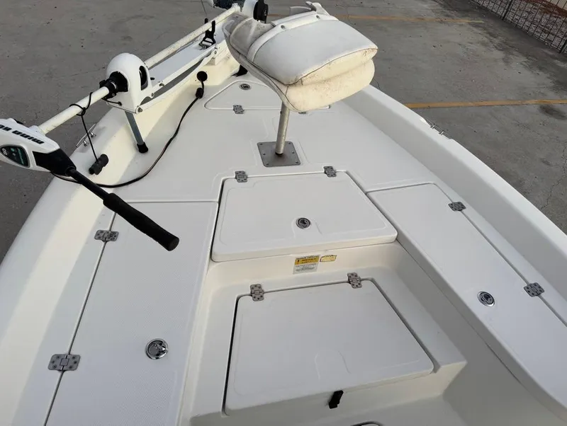 Slide: The Image of 2014 NauticStar 215 XTS Shallow Bay boat deck with seating and storage compartments. - 14