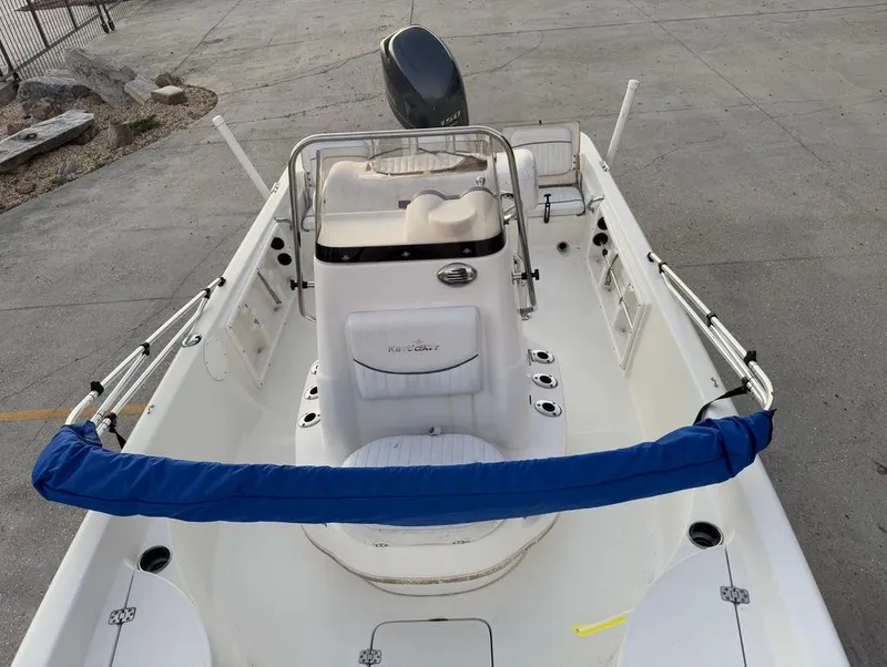 Slide: The Image of 2014 NauticStar 215 XTS Shallow Bay boat, white interior, center console, blue railing cover. - 15