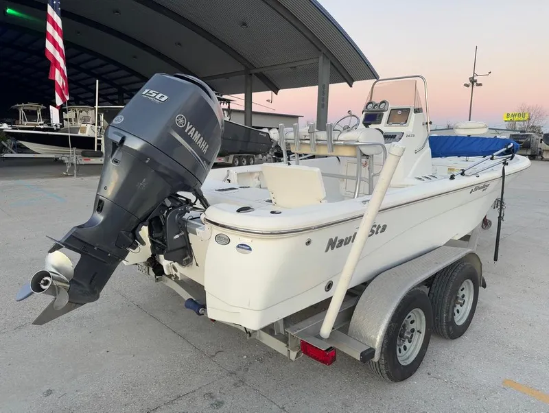 Slide: The Image of 2014 NauticStar 215 XTS Shallow Bay boat on trailer with Yamaha outboard motor. - 7