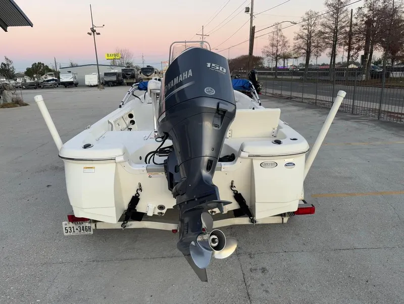 Slide: The Image of 2014 NauticStar 215 XTS Shallow Bay boat with Yamaha 150 engine, parked outdoors. - 8