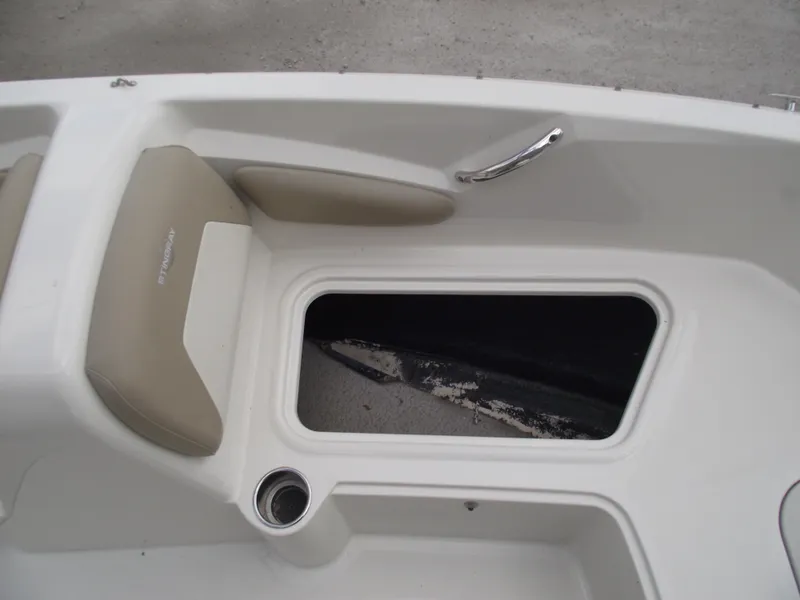 Slide: The Image of 2016 Stingray 182 SC boat interior with storage compartment and seating. - 10