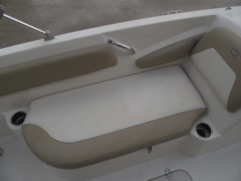 Slide: The Image of 2016 Stingray 182 SC boat interior seating with cup holders and beige upholstery. - 16