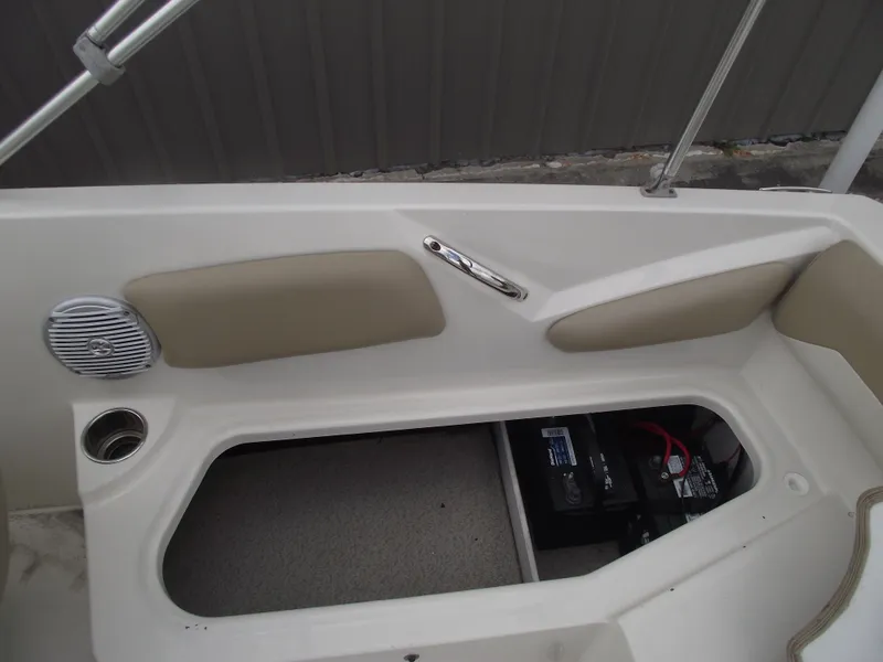 Slide: The Image of 2016 Stingray 182 SC boat interior with open storage compartment and speaker. - 19
