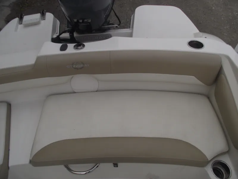 Slide: The Image of 2016 Stingray 182 SC boat interior seating with beige and white upholstery. - 20