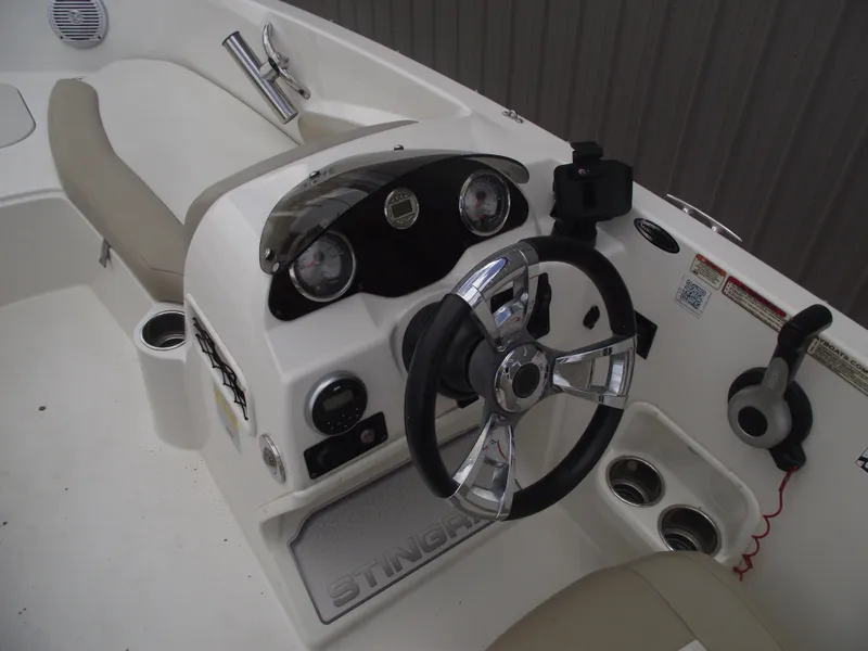 Slide: The Image of 2016 Stingray 182 SC boat dashboard with steering wheel and gauges. - 23