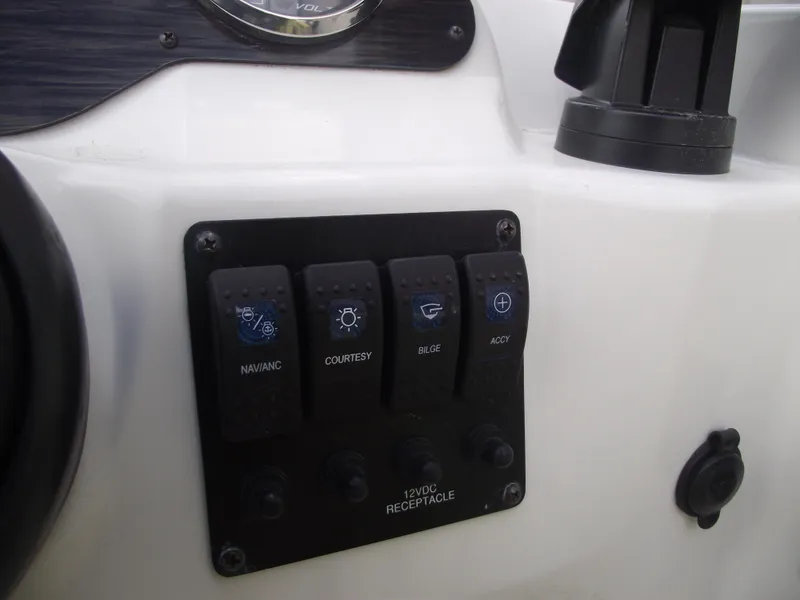 Slide: The Image of Control panel of 2016 Stingray 182 SC boat with labeled switches. - 27