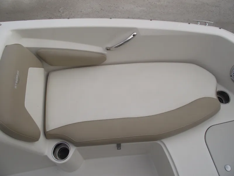 Slide: The Image of 2016 Stingray 182 SC boat interior with beige seating and stainless steel handle. - 9