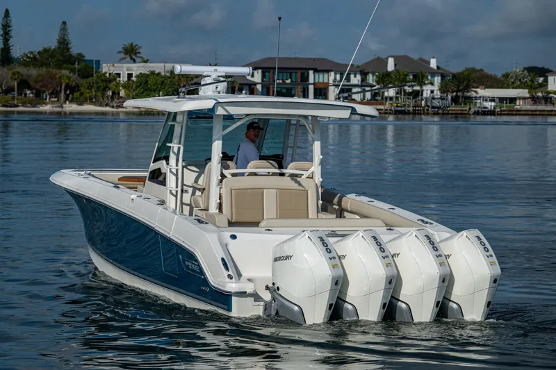 Slide: The Image of 2024 Boston Whaler 380 Outrage boat with triple engines on calm water. - 13