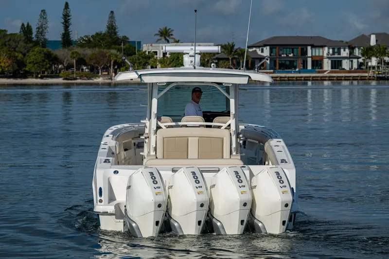 Slide: The Image of 2024 Boston Whaler 380 Outrage boat with four engines on calm water. - 15