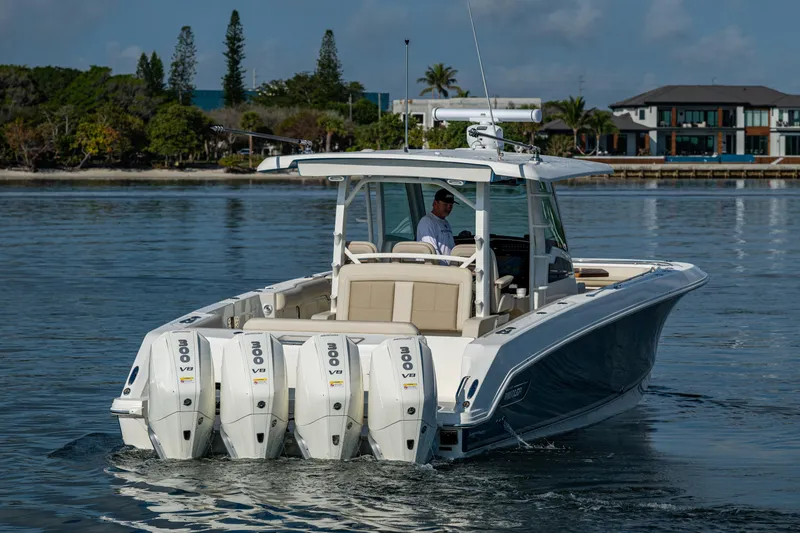 Slide: The Image of 2024 Boston Whaler 380 Outrage boat with quad engines on calm water. - 16