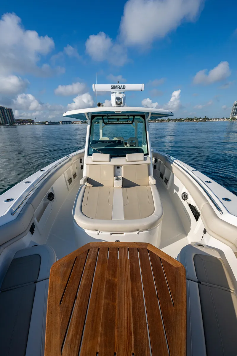 Slide: The Image of 2024 Boston Whaler 380 Outrage boat on calm water, clear sky background. - 30