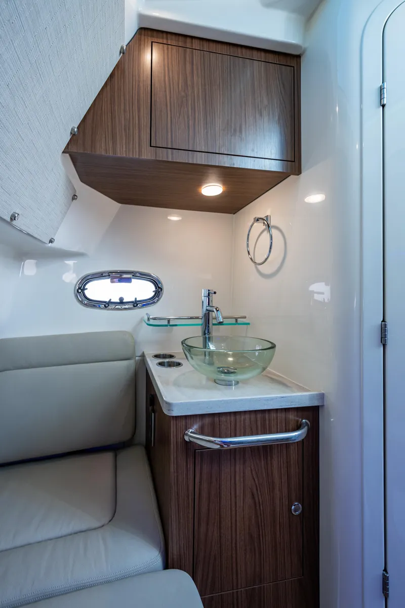 Slide: The Image of 2024 Boston Whaler 380 Outrage interior with modern sink and wooden cabinetry. - 33