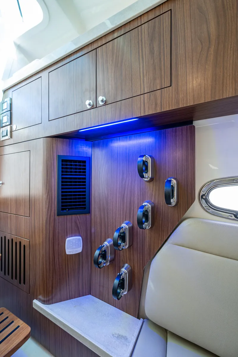 Slide: The Image of 2024 Boston Whaler 380 Outrage interior with wood cabinetry and modern lighting. - 34