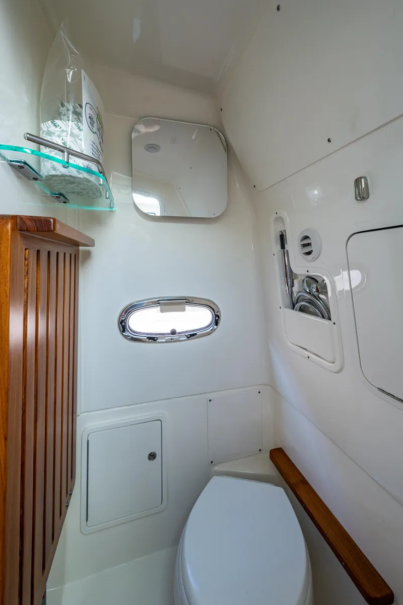 Slide: The Image of 2024 Boston Whaler 380 Outrage boat interior bathroom with modern amenities and sleek design. - 36