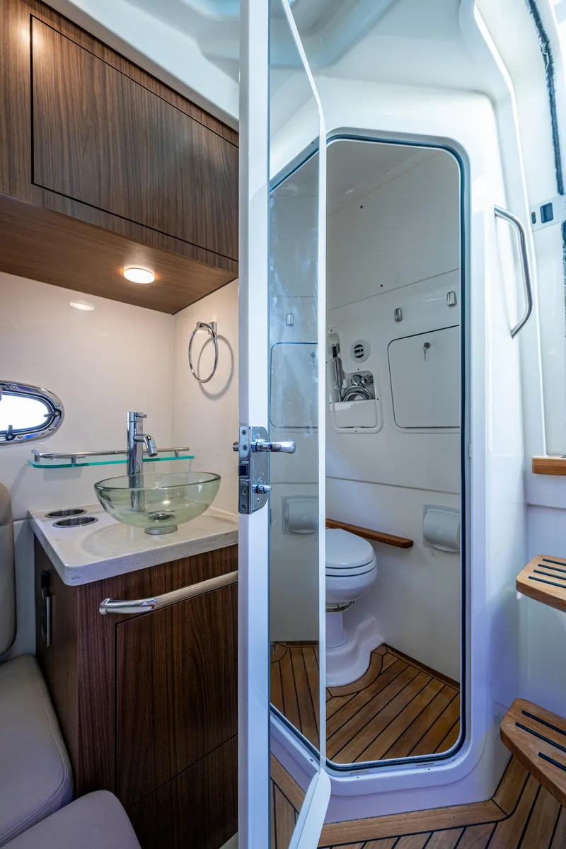 Slide: The Image of 2024 Boston Whaler 380 Outrage bathroom with modern fixtures and wooden accents. - 37