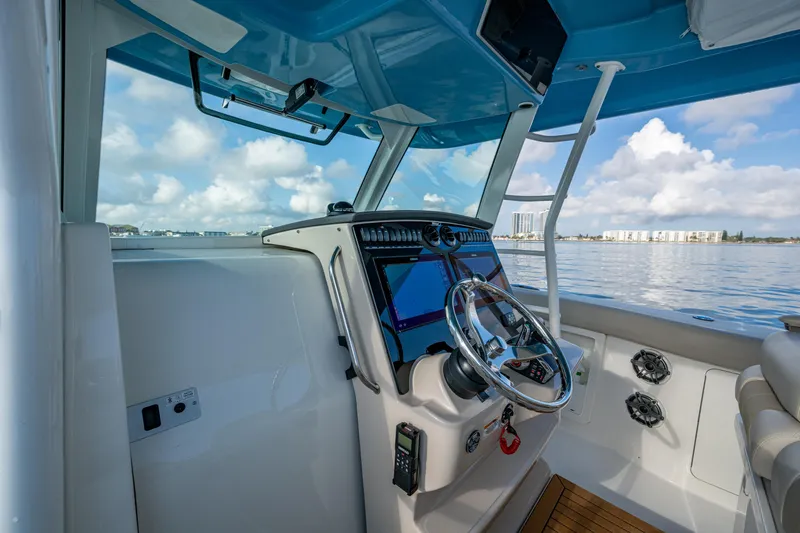 Slide: The Image of 2024 Boston Whaler 380 Outrage helm with modern controls and ocean view. - 39