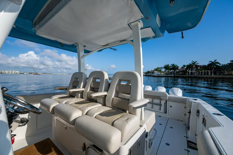 Slide: The Image of 2024 Boston Whaler 380 Outrage boat interior with luxurious seating and scenic water view. - 42