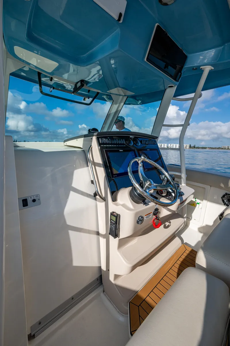 Slide: The Image of 2024 Boston Whaler 380 Outrage helm with modern controls and ocean view. - 44