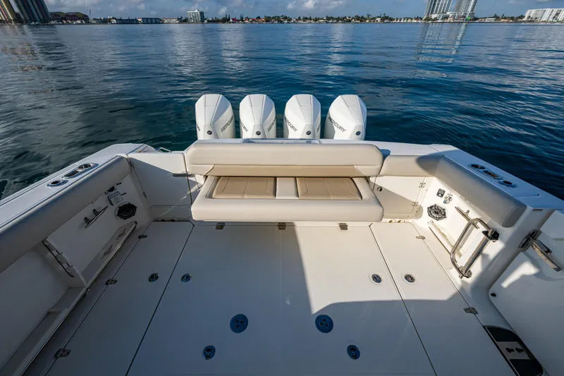 Slide: The Image of 2024 Boston Whaler 380 Outrage boat deck with quad engines, on calm water. - 47