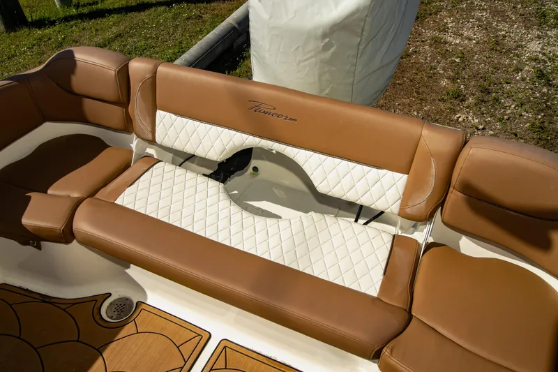 Slide: The Image of Brown and white seating on 2021 Pioneer 202 Islander boat, featuring quilted design. - 10