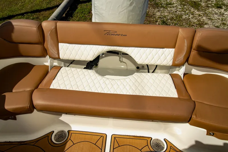 Slide: The Image of 2021 Pioneer 202 Islander boat seating with brown and white upholstery. - 11
