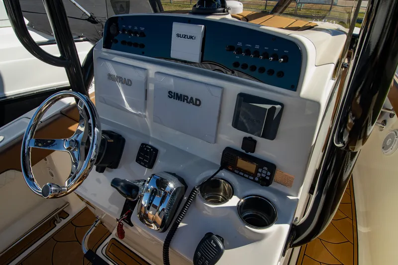 Slide: The Image of Control panel of 2021 Pioneer 202 Islander boat with steering wheel and navigation equipment. - 14