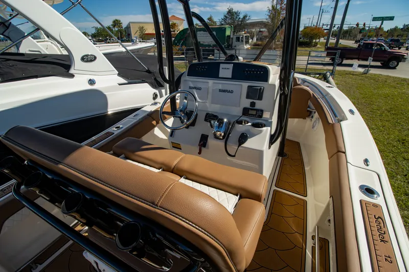 Slide: The Image of 2021 Pioneer 202 Islander boat interior with steering console and brown seating. - 18