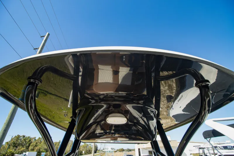 Slide: The Image of 2021 Pioneer 202 Islander boat's T-top viewed from below against clear blue sky. - 19