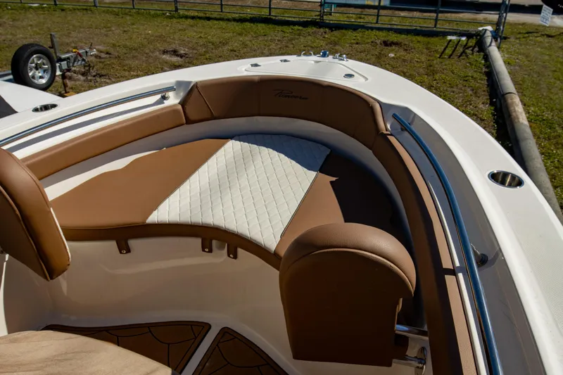 Slide: The Image of 2021 Pioneer 202 Islander boat interior with brown and white cushioned seating. - 23