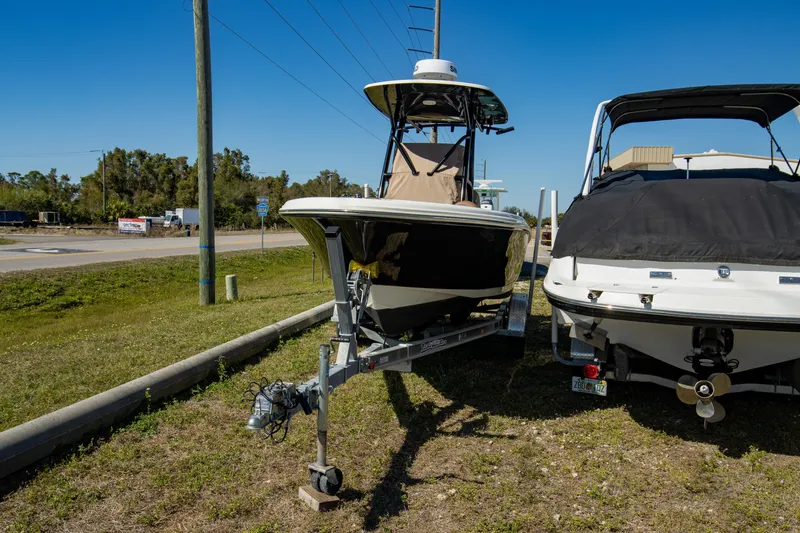 Slide: The Image of 2021 Pioneer 202 Islander boat on trailer, parked outdoors. - 26