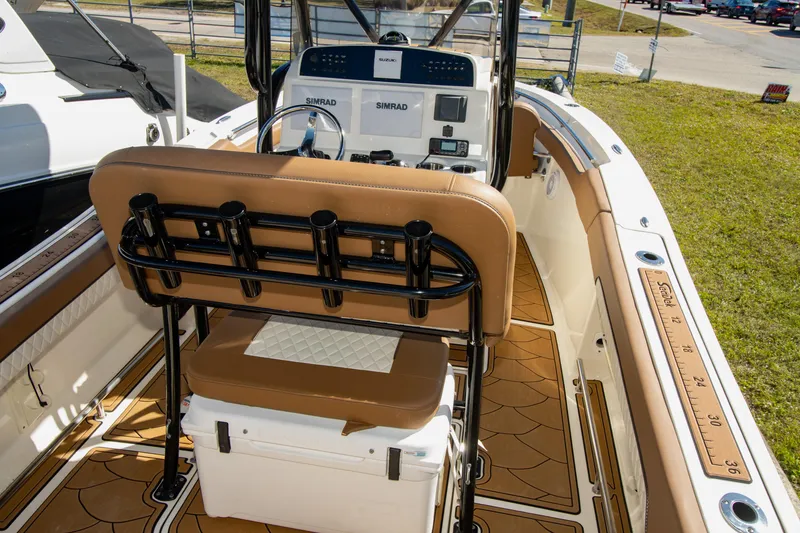 Slide: The Image of 2021 Pioneer 202 Islander boat interior with tan seating and modern dashboard. - 4