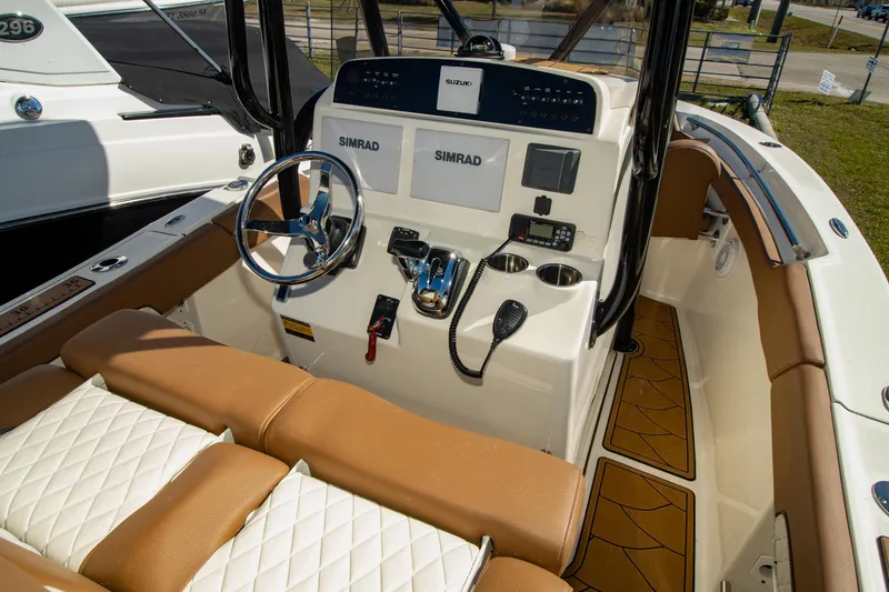 Slide: The Image of 2021 Pioneer 202 Islander boat interior with modern controls and tan seating. - 5