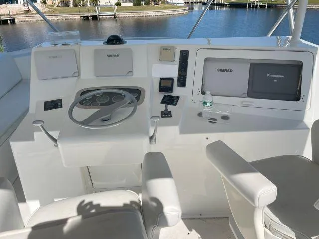 Slide: The Image of 1999 Viking 50 Convertible boat helm with steering wheel and navigation equipment. - 11