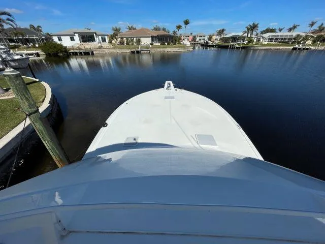 Slide: The Image of Bow view of 1999 Viking 50 Convertible yacht docked in a serene marina. - 19