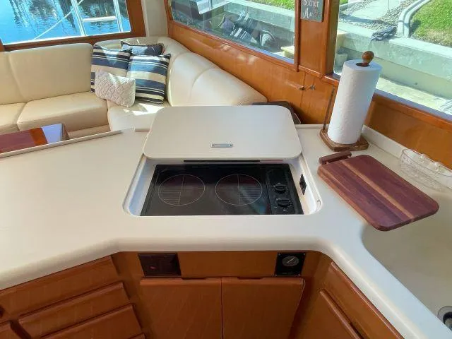 Slide: The Image of Interior of 1999 Viking 50 Convertible yacht with modern kitchen and seating area. - 25
