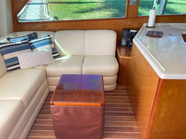 Slide: The Image of Interior of 1999 Viking 50 Convertible yacht with cream sofa and wooden accents. - 29