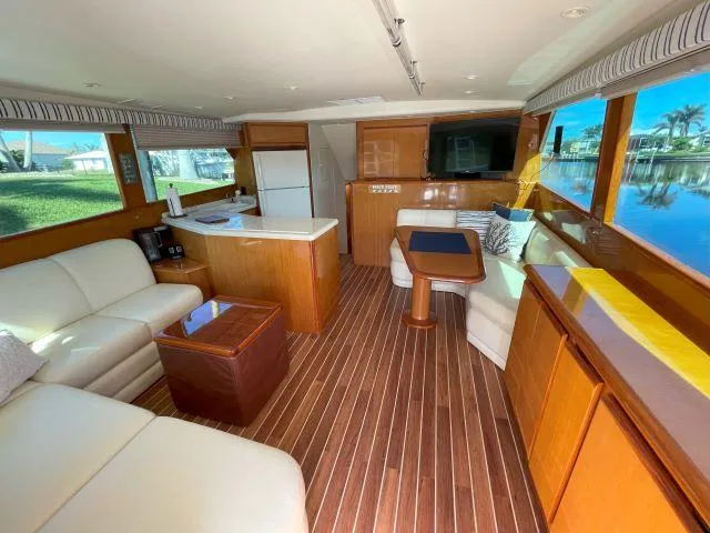 Slide: The Image of Luxurious interior of 1999 Viking 50 Convertible yacht with wood flooring and modern furnishings. - 30